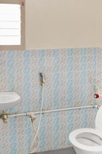 a bathroom with a toilet and a sink at HOTEL LS Residency in Salem