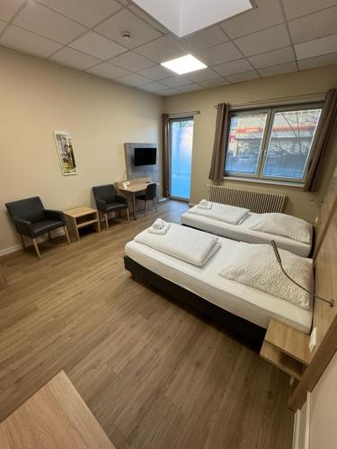 a hospital room with two beds and a desk at Boardinghaus-net in Fulda