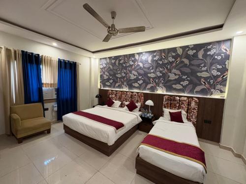 a hotel room with two beds and a chair at MJ Funcity Water Park & Resort in Lucknow