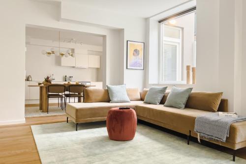 a living room with a couch and a table at Beautiful Apartments on Strøget in Copenhagen City Center in Copenhagen