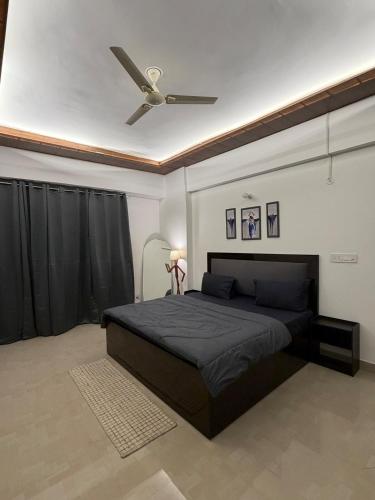 a bedroom with a bed with a ceiling fan at Shiva Stays - Make yourself at home in Lucknow