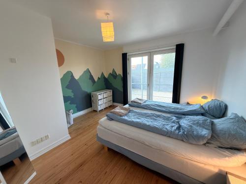 a bedroom with a large bed and a window at Central lejlighed i Herning in Herning
