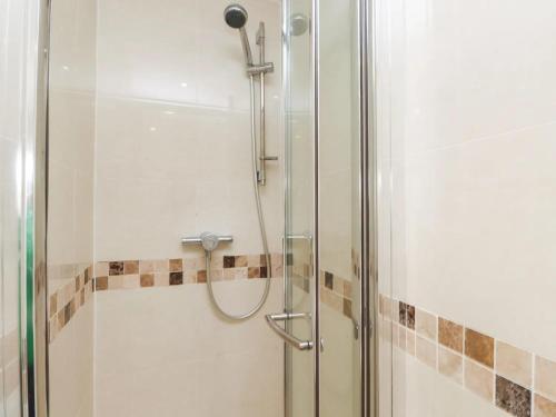 a shower in a bathroom with a glass door at The Hideaway in Llandudno