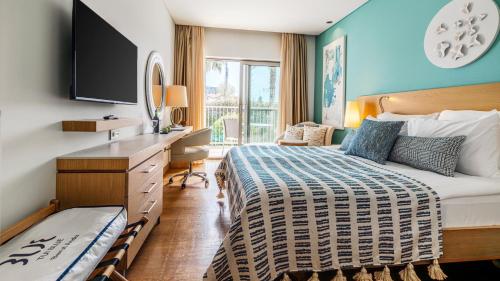 a hotel room with a large bed and a desk at TUI Blue Barut Andız - All Inclusive - Adults Only in Side