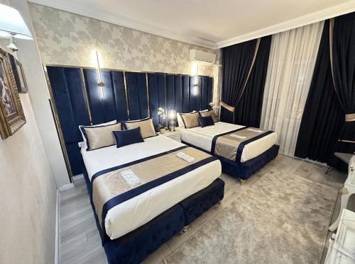 a hotel room with two beds in a room at B Corner Hotel Bistro in Istanbul
