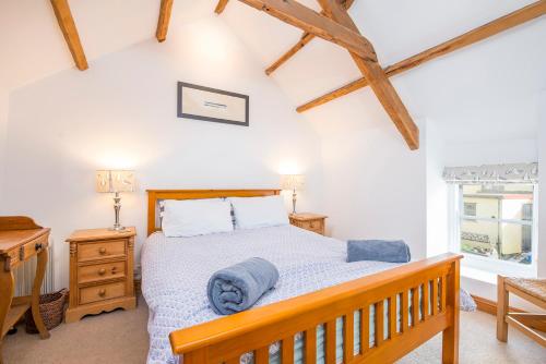 a bedroom with a wooden bed and a wooden bench at Ty Draw in HAW