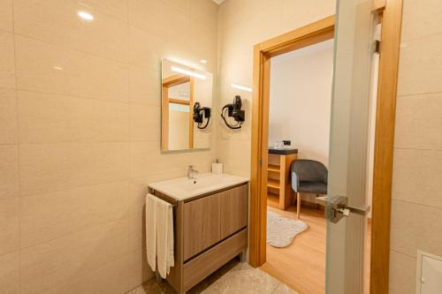 a bathroom with a sink and a mirror at Lena Village - Hotel and Spa in Mortágua
