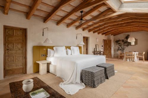 a bedroom with a large white bed in a room at Hotel Vestige Binidufà in Isla de Menorca