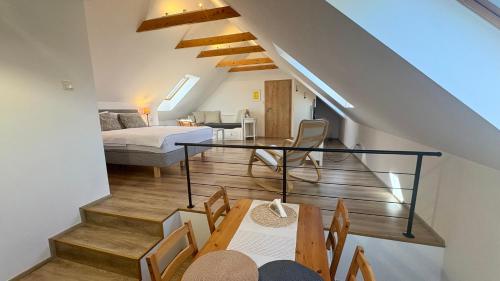 a bedroom and a living room with a bed and a table at Rezidence Věstonice in Horní Věstonice