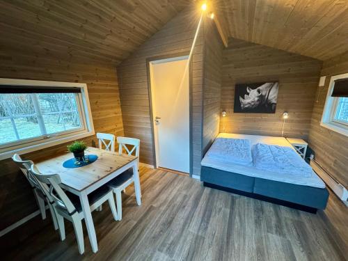 a bedroom with a bed and a table in a room at Trollstigen Resort in Åndalsnes