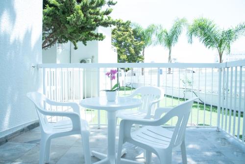 a white table and chairs on a balcony at Flisvos Beach Apartments in Protaras