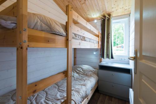 a bedroom with two bunk beds in a tiny house at Chateau De La Plinguetiere in Saint-Aignan-Grand-Lieu