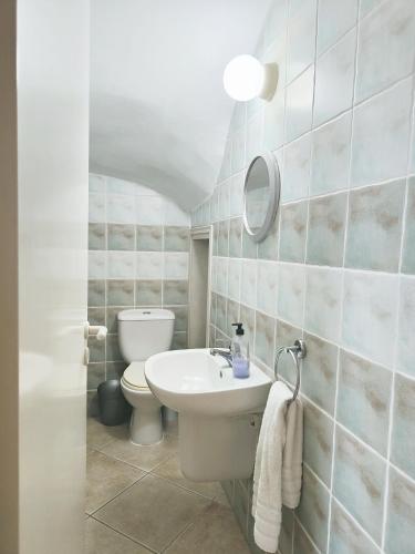 a bathroom with a sink and a toilet at Sunset View in Polis Chrysochous
