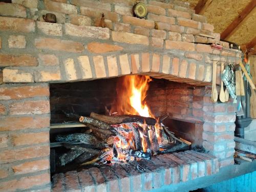 a brick oven with a fire in it at Kuca za odmor ViP in Kremna