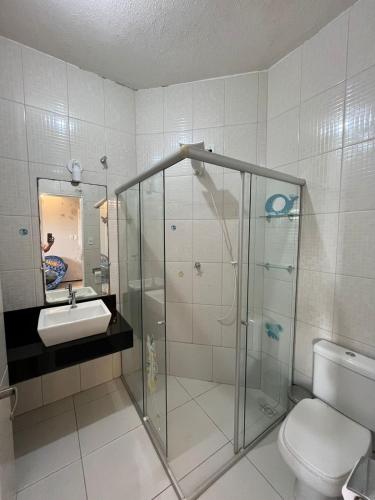 a bathroom with a shower and a toilet and a sink at Casa de praia in São Luís
