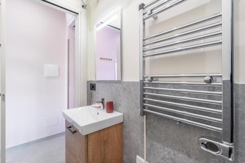 a bathroom with a sink and a shower at Seashell Luxury Rooms Sanremo in Sanremo