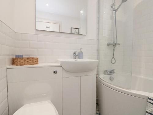 a bathroom with a sink and a toilet and a tub at The Nest in Bridlington