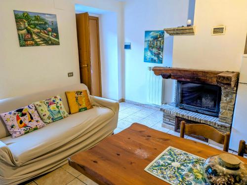 a living room with a couch and a fireplace at Lucoli Antico in Vado Lucoli