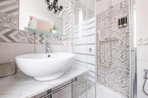 a white bathroom with a sink and a shower at Il galleone in Messina