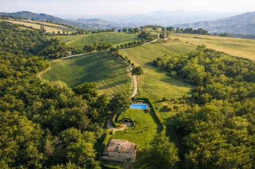 an aerial view of a farmhouse in a field at VILLA NASCA - Ville Carborello in Castelraimondo