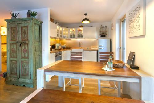 a kitchen with a wooden table in a room at Karwendelperle -419- in Mittenwald