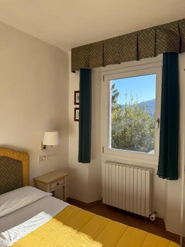 a bedroom with a bed and a large window at Il Fondaccio in Lizzano in Belvedere