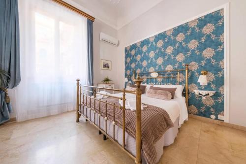 a bedroom with a bed and a blue wall at Il galleone in Messina