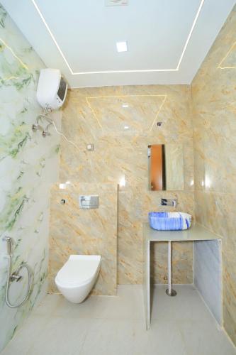 a bathroom with a toilet and a sink at Hotel Yash Palace in Agra