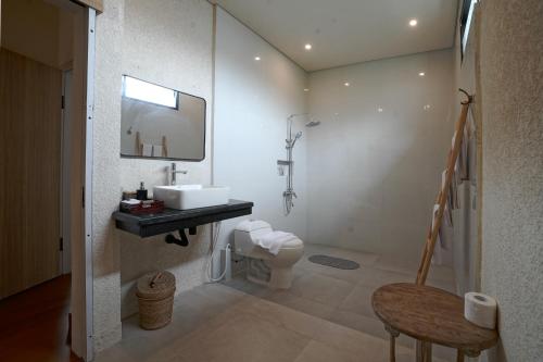 a bathroom with a sink and a toilet at Cleo Villa Padma Legian in Seminyak