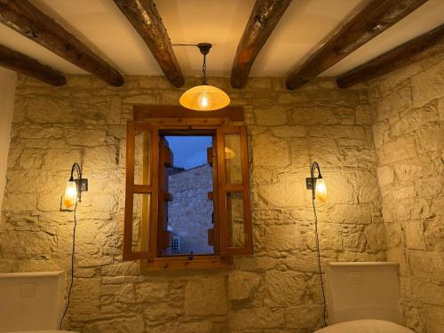 a room with a window in a stone wall at Vouni Calais in Vouni