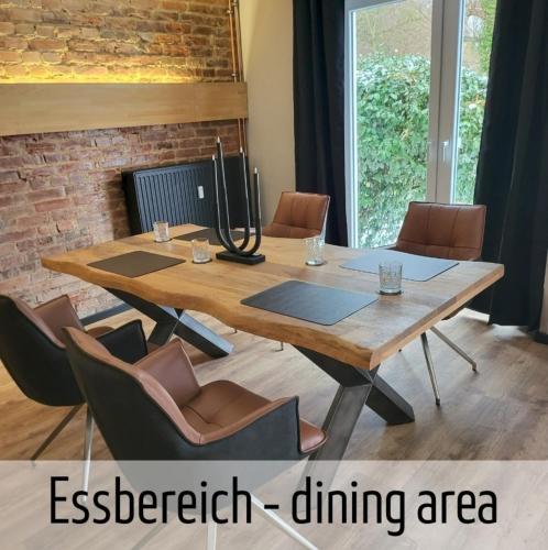 a conference room with a wooden table and chairs at Lokschuppen - Backstein-Loft in Bad Oeynhausen