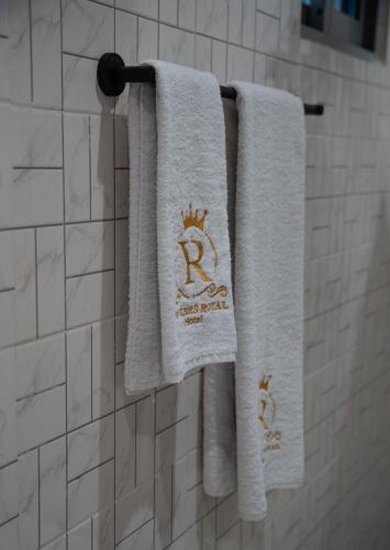 two towels with a crown on them hanging in a bathroom at Yankers Royal Hôtel Kinshasa in Kinshasa