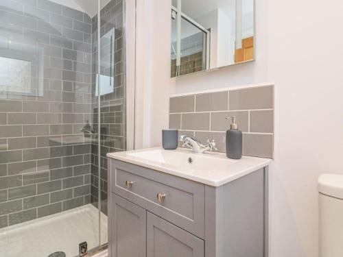 a bathroom with a sink and a shower at The Old Workshop in Dulverton