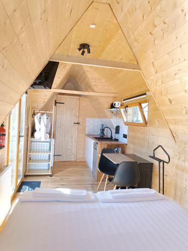 a room with a bed in a tiny house at Tiny Chaumière - Escapade Romantique - Chaumière et Jacuzzi Privatif proche Pont-Aven in Riec-sur-Bélon