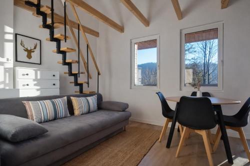 a living room with a couch and a table at Domek na Nowej Osadzie in Wisła