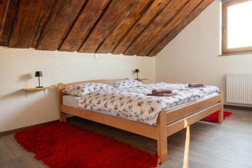 a bedroom with a bed with a wooden ceiling at Kuća za odmor Marija in Gospić