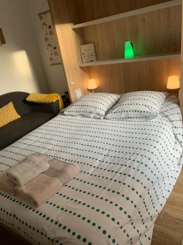 a bed in a bedroom with a green lamp at Le Cocon du Hameau in Bidart