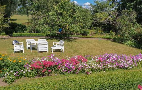 a group of chairs and flowers in a park at Gorgeous Home In Blentarp With Wifi in Blentarp