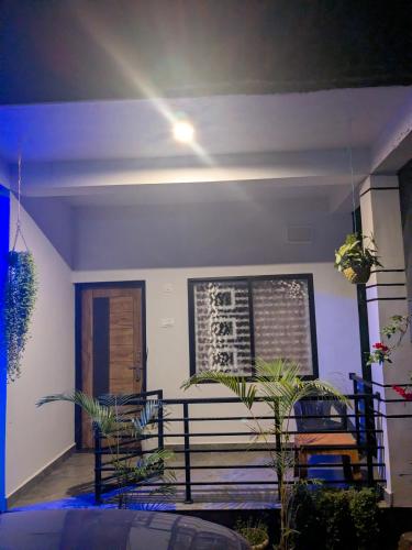 a house with a porch with two chairs and a door at Om Coast Gokarna in Gokarna