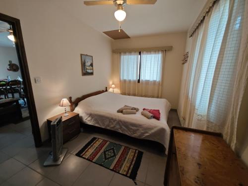 a bedroom with a bed and a tv in it at Mountain View 2BR House with Garden & Free Parking Ioannis Ylation Saranti in Nicosia