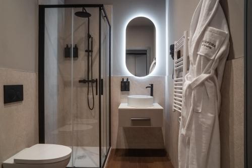 a bathroom with a shower and a toilet and a sink at Porpora Suite Hotel in Milan