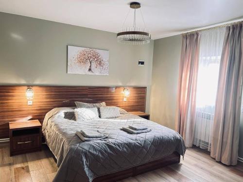 a bedroom with a large bed with a wooden headboard at Malishka Eco Villas