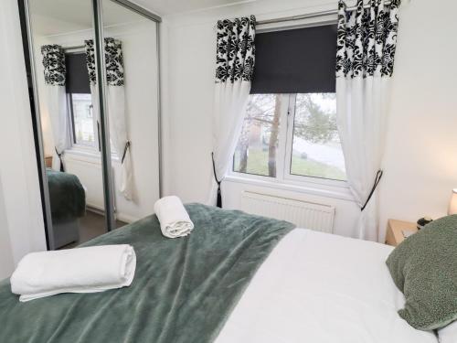 a bedroom with a bed and a large mirror at Harper's Hideaway in Morpeth