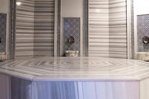 a shower with a white tub in a room at Alder Resort Hotel -Ultra All Inclusive in Kemer