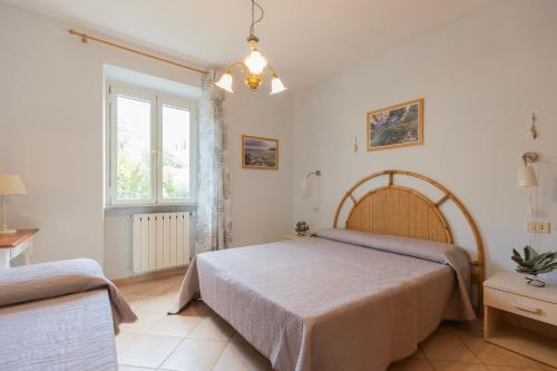 a bedroom with a large bed and a window at Appartamenti Belvedere by ElbaSummer in Lacona