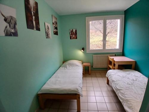 a room with two beds and a window at Centre de vacances Chausse in Chamborigaud