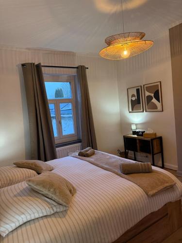 a bedroom with two beds and a window at Loft by GIORGI - Centre de Bastogne in Bastogne
