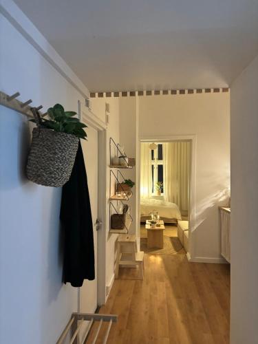 a hallway with a room with a bed and a door at Cozy Studio - 9 min Walk from Oslo Central Station in Oslo