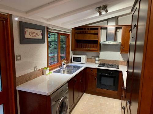 a small kitchen with a sink and a refrigerator at The Hermitage in Penrith