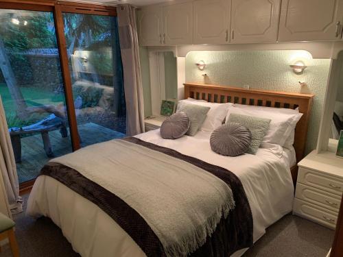 a bedroom with a bed with two pillows on it at The Hermitage in Penrith